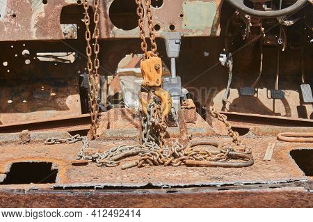 Reel And Chain And U Bolt And Automatic Gear Handle On Rusty Old Car Interior
