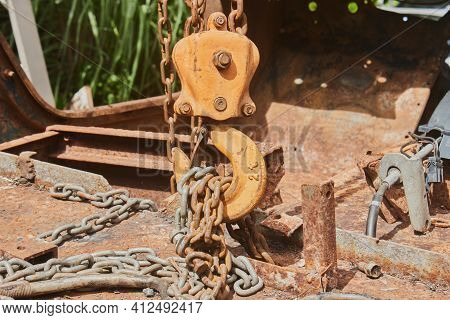 Front View Reel And Chain And U Bolt On Rusty Old Car Interior