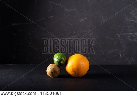 Figure From Different Fruits On A Black Background. Multi-colored Fruits On A Black Background. Roun