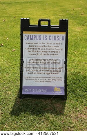 March 12, 2021 - Whittier, California: Whittier College. Coronavirus Campus Closed Sign. Campus is closed due to Covid-19. Sign on lawn. Editorial Use Only. 