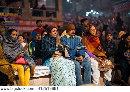 17.12.2019, Varanasi, India. The Sacred Religious Ceremony Of Arati. People Sits Praying And Watchin