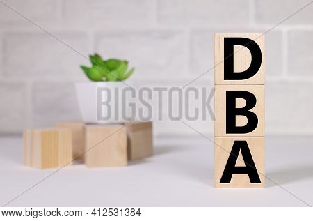 Dba. Doctor Of Business Administration. Text On Wood Cubes. Text In Black Letters On Wood Blocks