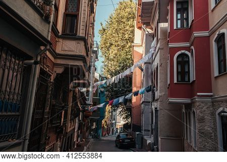 Istanbul, Turkey - November 12, 2020: Car And Clothesline With Laundry Between Houses On Narrow Stre