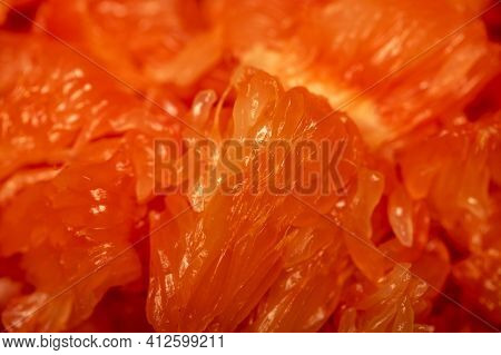 Red Honey Pomelo Peeled And Disassembled Into Slices. Close-up Selective Focus.
