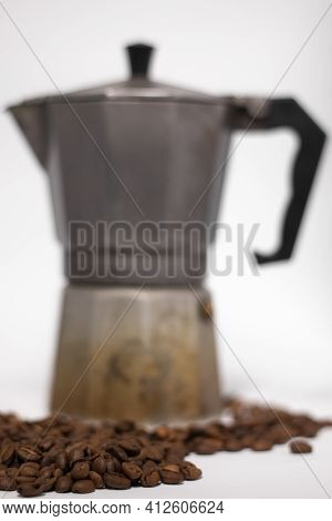 Geyser Coffee Maker Or Moka Pot Isolated On White Background With Coffee Beans Nearby.