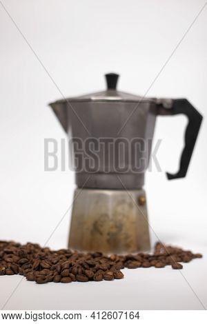 Geyser Coffee Maker Or Moka Pot Isolated On White Background With Coffee Beans Nearby.