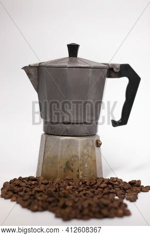 Geyser Coffee Maker Or Moka Pot Isolated On White Background With Coffee Beans Nearby.