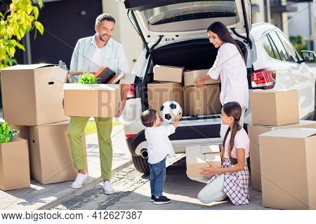 Full Size Photo Of Smiling Happy Family Moving Pack Stuff Dad Mom And Sister Watch Little Boy Put Ba
