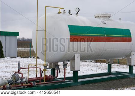 Industrial Propane Gas Tank Cistern Reservoir At Car Gas Station. High Quality Photo
