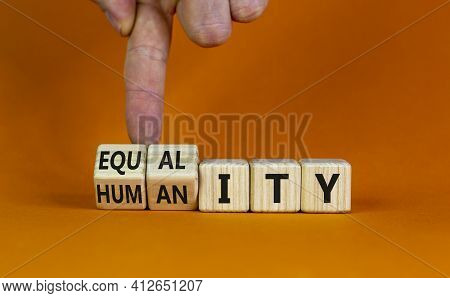 Equality And Humanity Symbol. Businessman Turns Wooden Cubes And Changes The Word 'equality' To 'div