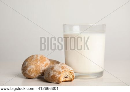 Tasty Homemade Gingerbread Cookies And Glass Of Milk On White Table