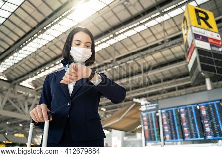 Cabin Crew Or Air Hostess Wearing Face Mask Walking In Airport Terminal To The Airplanel During The 