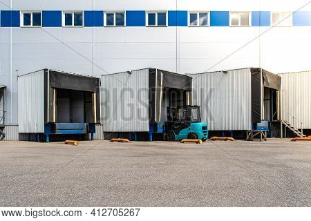 General View To The Loading Gates In The Big Distribution Warehouse With Forklift