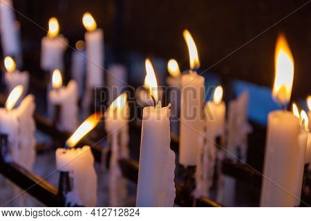 Several Candles Burning With One Candle Sharp And Others Blurred