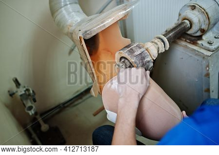 Prosthetist Man Making Prosthetic Leg While Working In Laboratory.