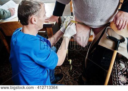 The Prosthetist Removes The Measure From A Person With A Disability, Woman With Amputee.