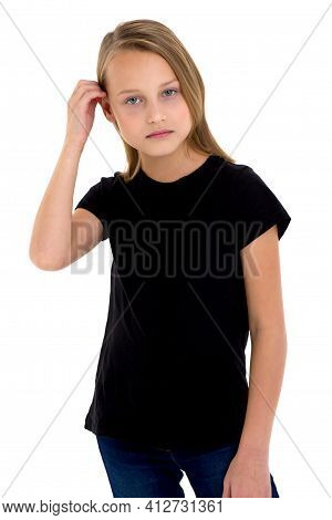 Pretty Blonde Girl In Black T-shirt. Girl In Fashionable Clothes Straightening Her Hair Posing In St