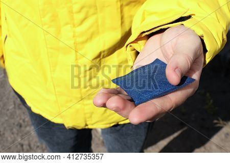 Man Holding Hand Warmer Outdoors, Closeup View
