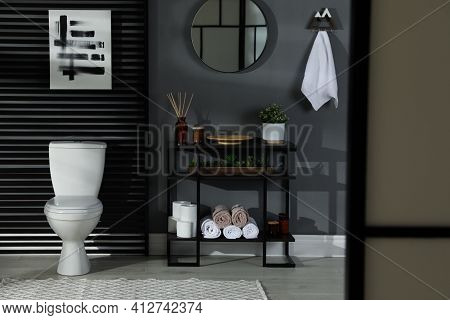 Modern Bathroom Interior With Toilet Bowl And Console Table