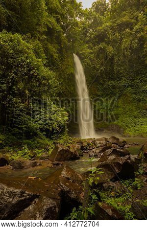 Waterfall Landscape. Beautiful Hidden Waterfall In Tropical Rainforest. Foreground With Big Stones. 
