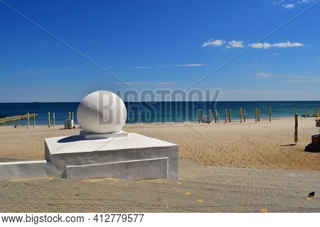 Sea Wave Breaks On Beach Rocks Landscape. Bright Summer Sunny Day. The Stone Lies On The Beach. Larg