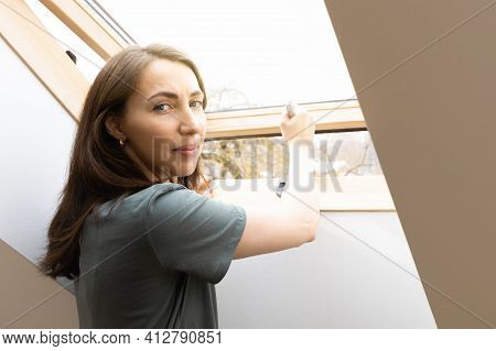 Women Opening A Window At Home Office And Letting Fresh Air In. Healthy Working Environment In New N
