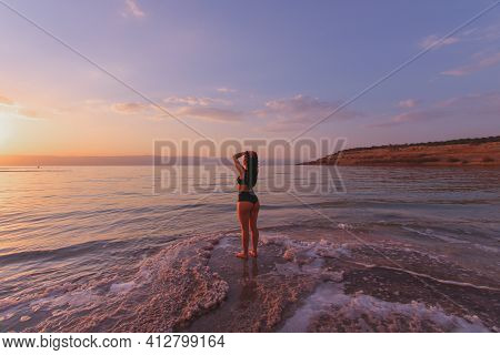 Young Lady In Bikini Looking At The Sunset At Dead Sea, Jordan