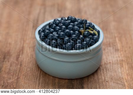 Blueberries On Rustic Rown Wooden Board Background. Healthy Eating