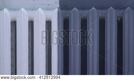 Old Room Heating Radiator Painted Half White, Half Gray, Design Solution For The Color Scheme Of The