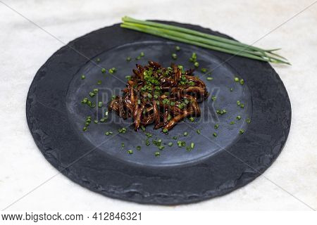 Shimeji Mushroom Served With Chives On Black Stone Plate. Typical Oriental Meal. Detail Of Food Dish