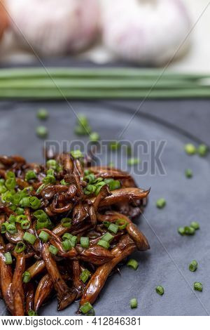 Shimeji Mushroom Served With Chives On Black Stone Plate. Typical Oriental Meal. Detail Of Food Dish
