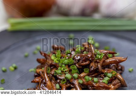 Shimeji Mushroom Served With Chives On Black Stone Plate. Typical Oriental Meal. Detail Of Food Dish