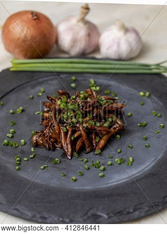 Shimeji Mushroom Served With Chives On Black Stone Plate. Typical Oriental Meal. Detail Of Food Dish