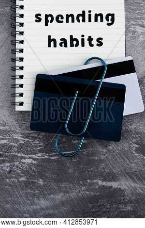 Spending Habits Text On Notepad With Payment Cards Next To It, Money And Consumer Behaviour Conceptu