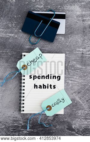 Spending Habits Text On Notepad With Payment Cards And Cheap Vs Costly Prioduct Price Tags Next To I
