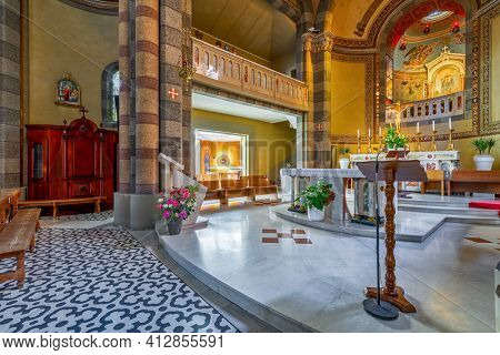 ALBA, ITALY - JUNE 23, 2020: Altar and confession booth as part of the interiors of Madonna della Moretta church in Alba - small town in Piedmont region famous for its white truffles and wines.