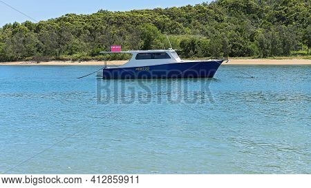 Mackay, Queensland, Australia - March 2021: A Fishing Cabin Cruiser For Sale Anchored In A Creek