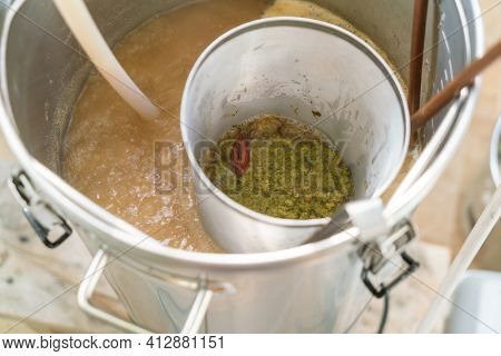 The process of home brewing beer using malt. Craft beer brewing from grain barley pale malt in process.