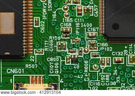 Green Electronic Board With Radioelements Close-up. Background For The Theme Of Electronics And High