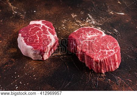 Raw Fillet Mignon Tenderloin Steaks. Dark Background. Top View