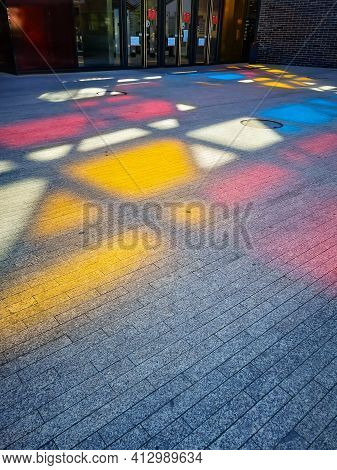 Wroclaw, Poland - May 29 2020: Colorful Shapes On The Ground Made By Shining Sun Behind Colorful Win