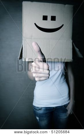 faceless girl with box on her head LIKE with thumb up, social network concept, toned