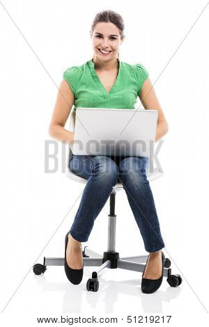 Famele happy student sitting on a chair with a laptop, isolated over a white background