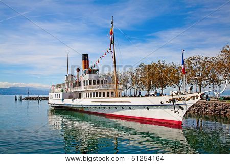Vintage steam boat near the pier on the lake Leman (Switzerland)