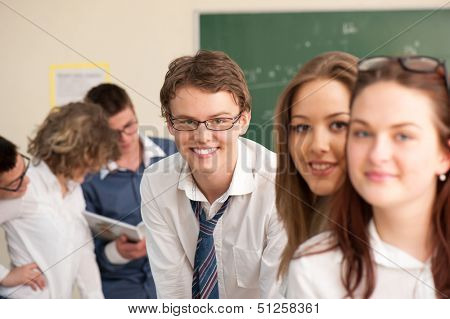 Posing group of handsome students in a schoolroom