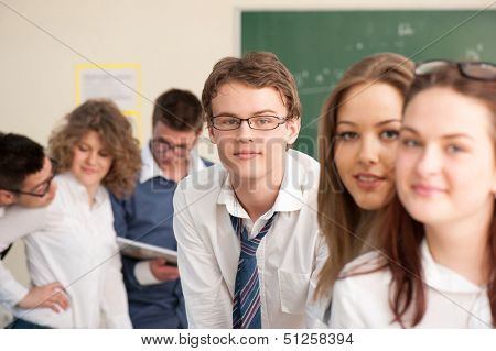 Six students in a schoolroom during a breaktime