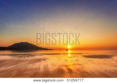 Tropical beach in ebb time on sunset background