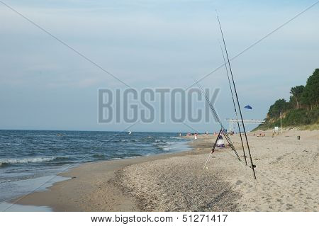 Fishing Rods On Sandy Beach