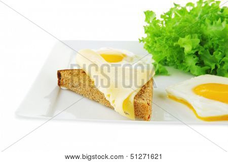 two fried eggs with salad bread and cheese