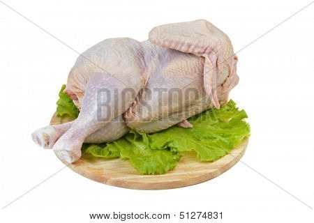 Whole raw chicken rest on kitchen board wait for cooking